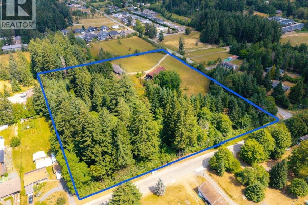 Aerial view showcasing the wooded area within the property boundaries at 5526 Grandview Rd, Port Alberni. - 5526 Grandview Rd, Port Alberni