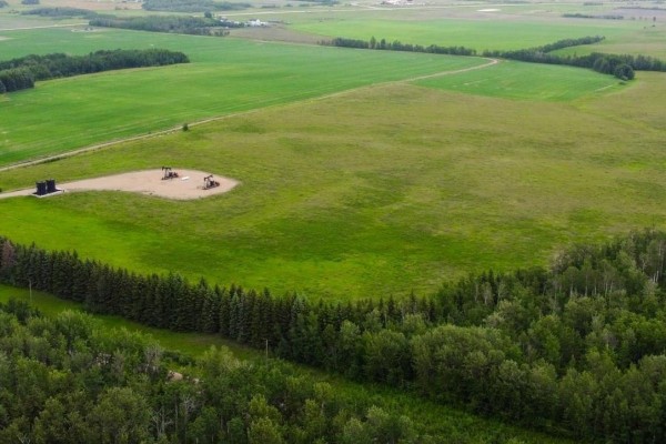 Drone shot of a large agricultural property with cultivated fields, bordered by forest and dirt roads. - 553-lot D Range Road 201, Rural Lamont County