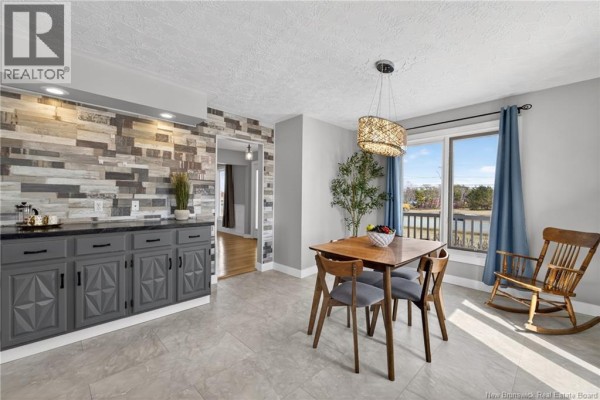 Attic room with sloped ceiling, light wood floor, white bi-fold doors, and ceiling fan. - 5551 Route 11, Riviere Du Portage