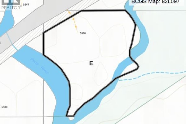 Unpaved, rocky path winds through a wooded area with mature evergreen and deciduous trees. - 5568 Trans Canada Highway, Malakwa