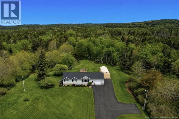 Office space with a desk, chair, storage cabinets, and a display cabinet. - 558 Route 776, Grand Manan