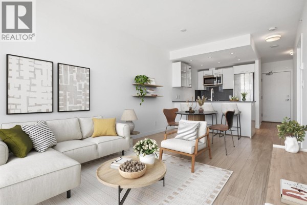 Open concept living area with a sectional sofa, dining table, and modern kitchen with white cabinets. - 559 955 E Hastings Street, Vancouver