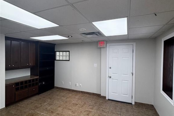 Office space with dark wood built-in cabinets, tiled floor, and white door. - 559 Exmouth Street Unit# C, Sarnia