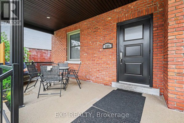 Aerial view of a multi-story brick building with a pitched roof and surrounding trees. - 559 Parkdale Avenue, Ottawa