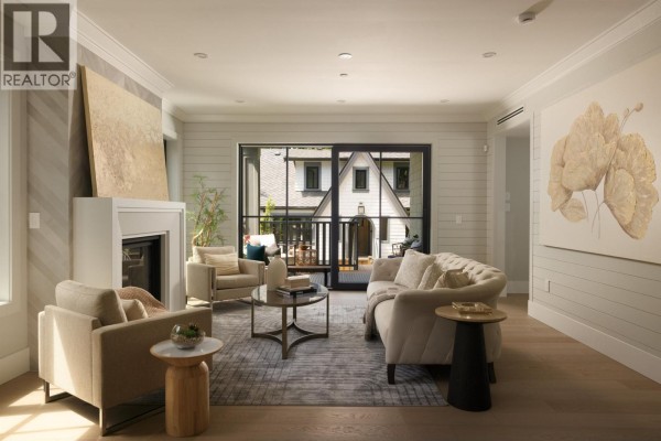 Living room with a fireplace, two sofas, armchairs, glass coffee table, and sliding doors opening to the exterior. - 5593 Mackenzie Street, Vancouver