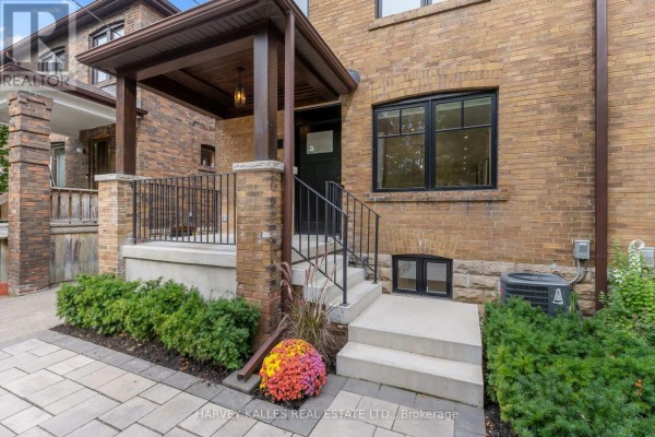 Close-up of the covered porch and entrance stairs of a brick home. - 56 Glengarry Avenue, Toronto