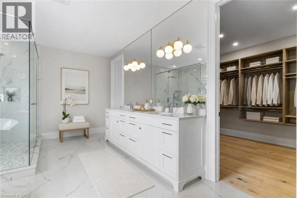 Modern bathroom with double vanity, glass shower, soaking tub, and walk-in closet - 56 Pioneer Ridge Drive Kitchener