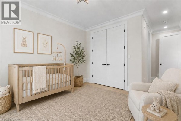 Nursery with crib, armchair, and wall art - 56 Pioneer Ridge Drive Kitchener