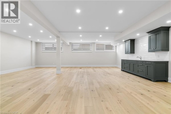 Built-in bar with subway tile backsplash and hardwood floors - 56 Pioneer Ridge Drive Kitchener