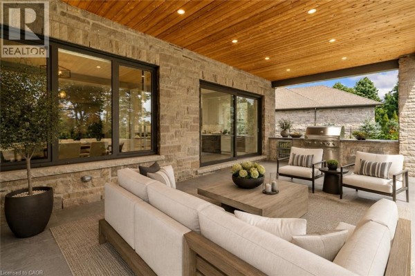 Covered patio with outdoor kitchen and seating - 56 Pioneer Ridge Drive Kitchener