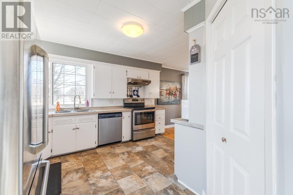 A laundry room with white washer and dryer, open shelving, and pegboard detailing. - 56 Regent Street, Amherst
