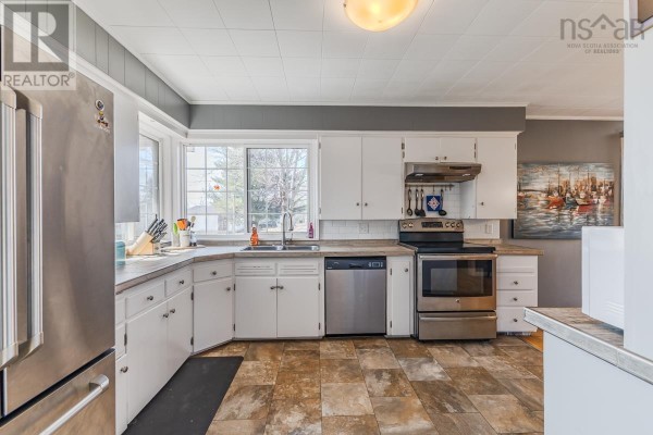 A bedroom featuring a bed, built-in beige closet storage, and hardwood floors. - 56 Regent Street, Amherst