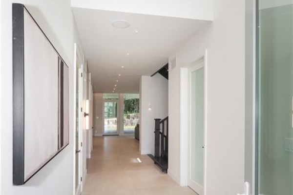 Long, bright hallway with beige tile floors and doors on both sides. - 560 Werni Court, Waterloo