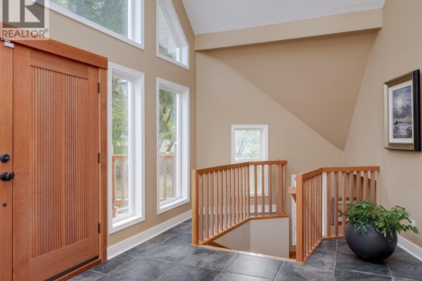 Kitchen with mint green cabinets, stainless steel appliances, and a white quartz countertop island. - 560 Wilderness Pl, Sooke