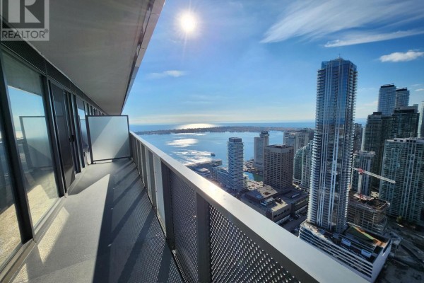 Balcony overlooking Toronto skyline and Lake Ontario on a sunny day. - 5601 - 55 Cooper Street, Toronto