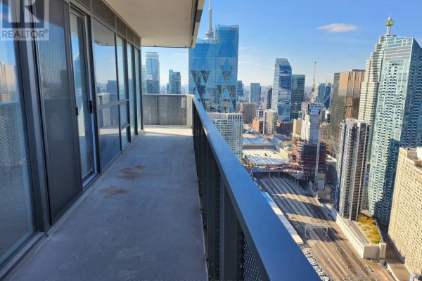 Balcony view of Toronto's dense urban landscape with skyscrapers and railway tracks. - 5601 - 55 Cooper Street, Toronto