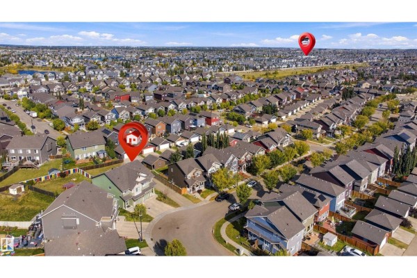 Aerial view of the duplex property and surrounding residential area under a blue sky. - 5604 Crabapple Wy Sw, Edmonton