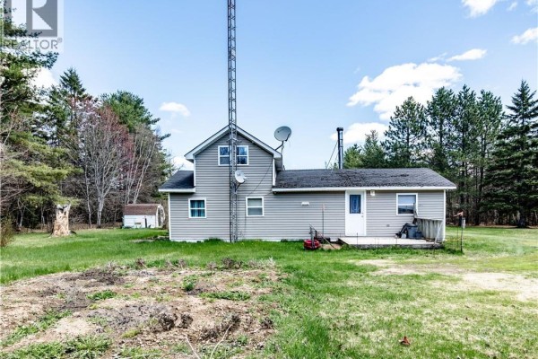 Home office space with a computer desk, large window, and door to the outside. - 561 Gray Road, Saint Charles