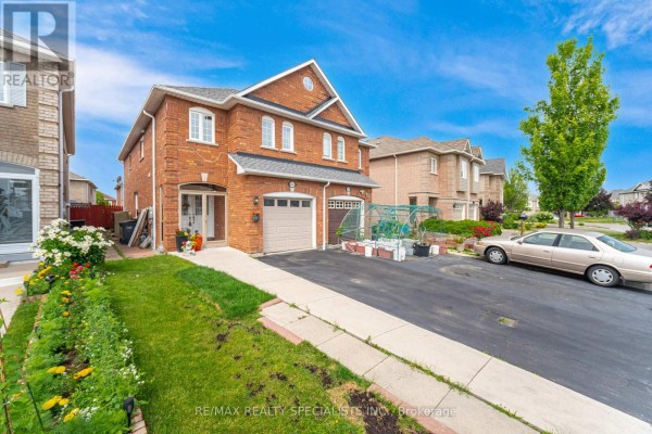 Side view of a brick house with a driveway, lawn, and surrounding homes. - 5642 Armando Avenue, Mississauga