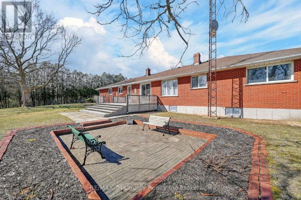 Brick house rear exterior with deck and patio - 568 7th Concession Enr Road Norfolk