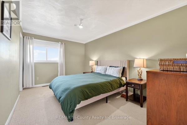 Bedroom with bed, nightstands, dresser, ceiling fan - 568 7th Concession Enr Road Norfolk