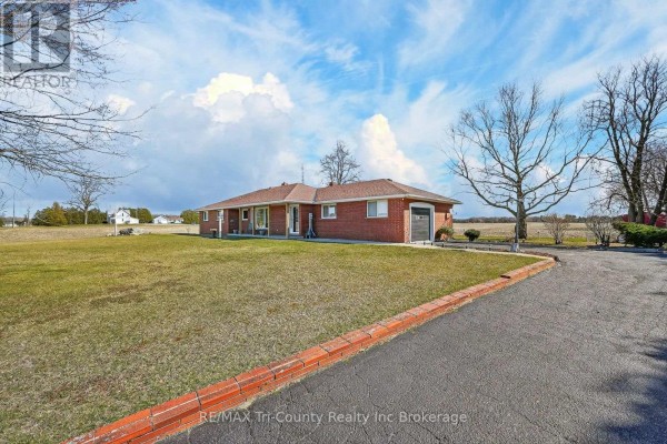 Red brick ranch home with attached garage and large lawn - 568 7th Concession Enr Road Norfolk