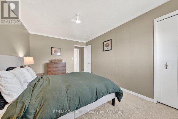 Bedroom with bed, dresser, nightstand, and closet - 568 7th Concession Enr Road Norfolk