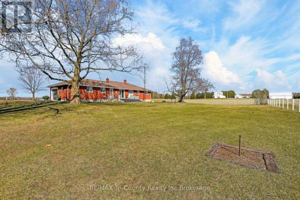 Red brick ranch house with attached garage, mature trees, and horseshoe pit - 568 7th Concession Enr Road Norfolk
