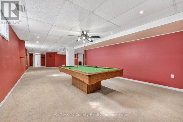 Pool table in a finished basement with red walls - 568 7th Concession Enr Road Norfolk