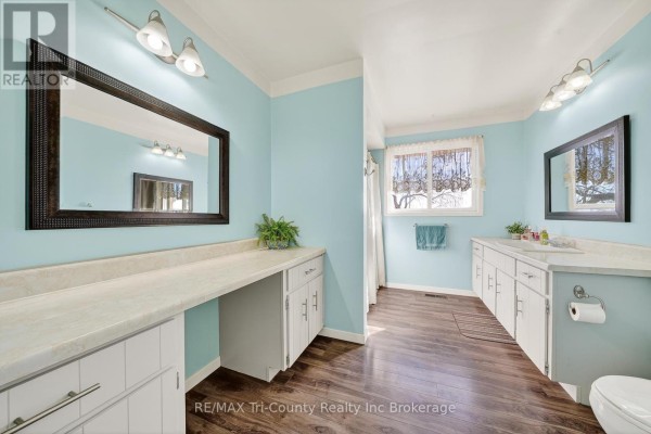 Bathroom vanity with large mirror and wood floors - 568 7th Concession Enr Road Norfolk