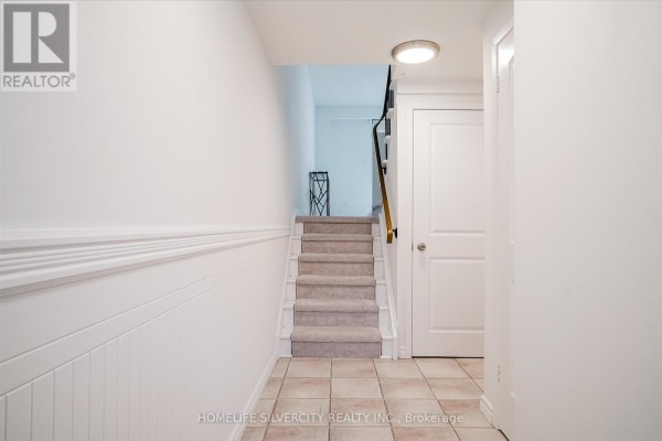 Staircase leading to upper levels with carpeted steps and white railing - 57 - 235 Bronte Street S, Milton
