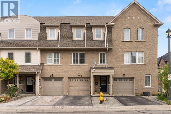 Exterior of a brick townhouse with attached garages and multiple windows under a grey shingled roof. - 57 - 3 Brisby Mews, Toronto