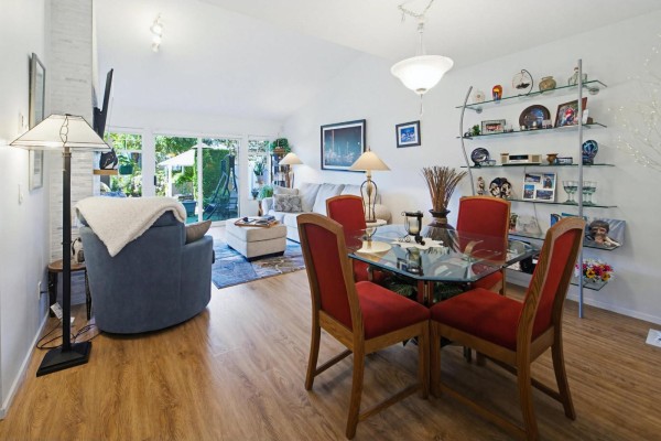 Entryway to townhouse with patio furniture, potted plants, and stone garden beds. - 57 8737 212 Street, Langley