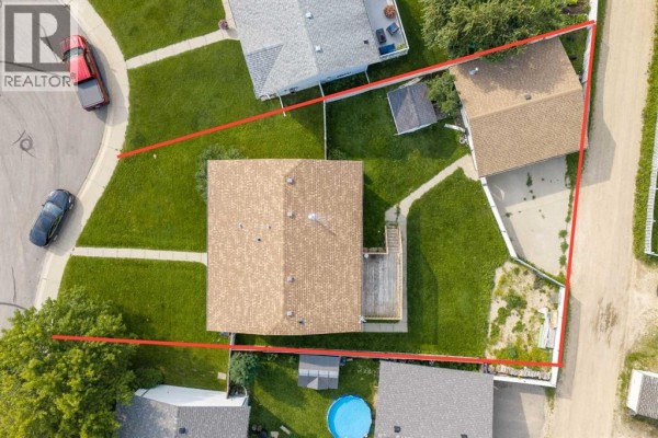 Overhead view of the property at 57 Atkinson Crescent, showing the house, backyard, and garage. - 57 Atkinson Crescent, Whitecourt
