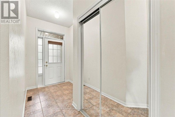 Deck with wood tile flooring and metal railing overlooking townhouses. - 57 Barkdale Way, Whitby