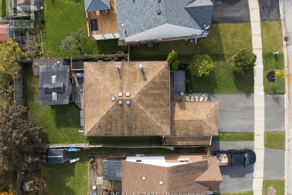 Aerial view of a residential house with a brown shingled roof and surrounding properties. - 57 Fenwick Avenue, Clarington