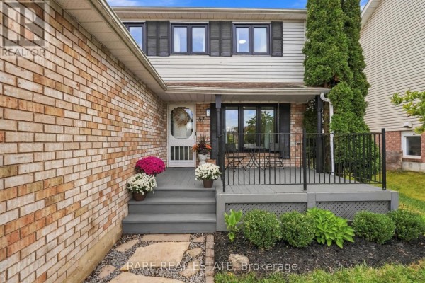 Close-up of the front porch of a house, showing steps, railings, and potted flowers. - 57 Fenwick Avenue, Clarington