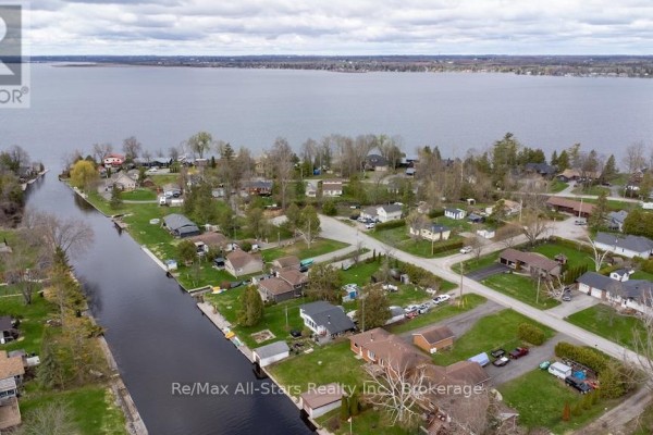 Aerial view of canal homes and large lake with wooded shoreline. - 57 Indian Trail, Kawartha Lakes