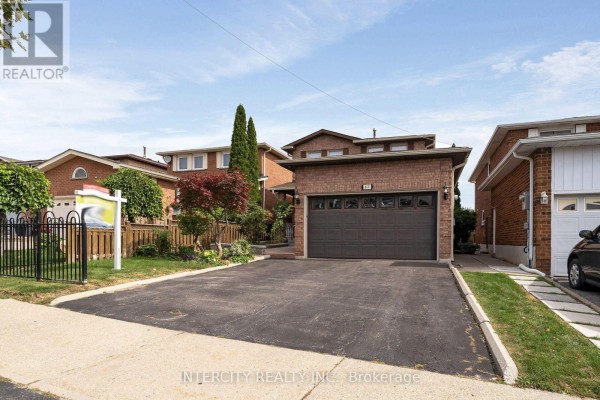 Exterior view of a suburban brick house with a manicured lawn and fence. - 57 Kaiser Drive, Vaughan