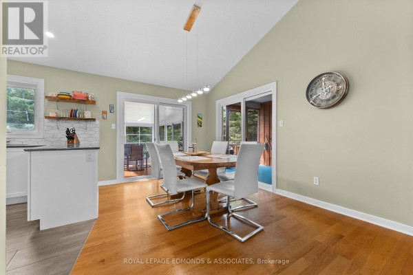 Dining area with wooden table and white chairs - 57 Krause Street Laurentian Valley