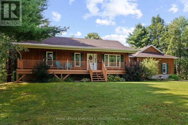 Front facade of a light brown wooden home with a covered porch. - 57 Krause Street, Laurentian Valley