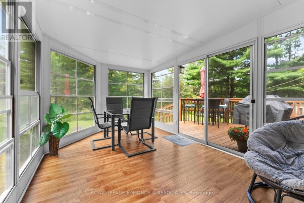 Sunroom with dining set and deck access - 57 Krause Street Laurentian Valley