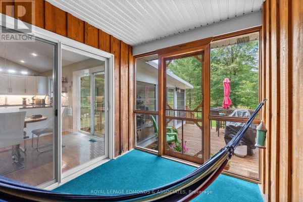 Screened-in porch with hammock, deck with grill, and kitchen view - 57 Krause Street Laurentian Valley