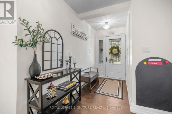 Foyer with a black console table, arched mirror, and a bench. - 57 Sabrina Drive, Toronto