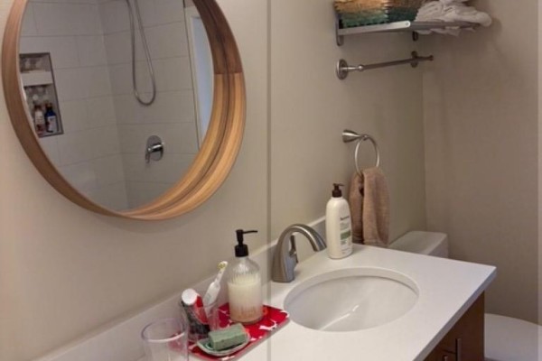 Bathroom featuring a double vanity, mirrors, and modern fixtures. - 5702 Medusa Street, Sechelt