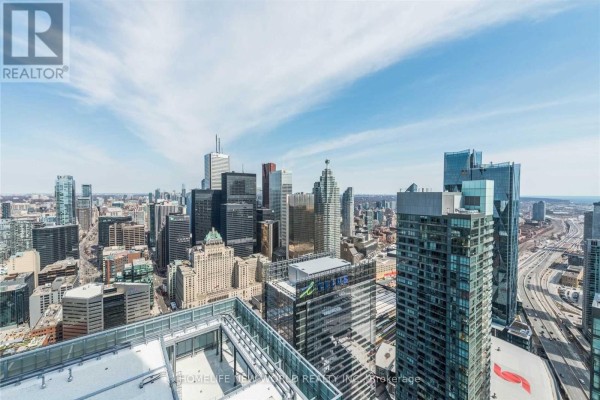 Toronto skyline view featuring skyscrapers and the Gardiner Expressway from high-rise balcony. - 5709 - 14 York Street, Toronto