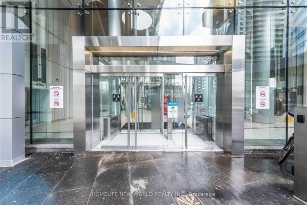 Stainless steel revolving doors with glass entrance and signage for building 14 York Street. - 5709 - 14 York Street, Toronto