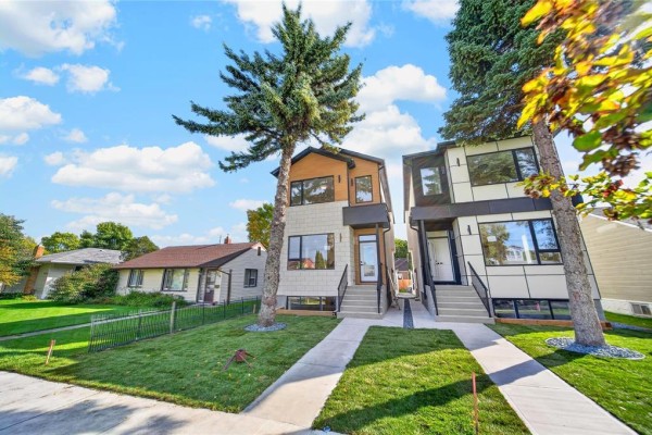 A wide shot of the duplex exterior, showing its contemporary design and landscaping. - 572 Centennial Street, Winnipeg