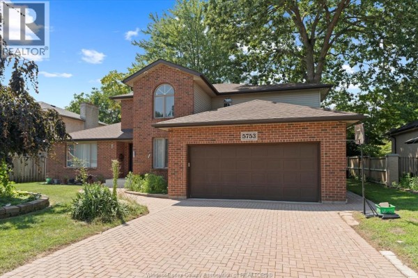 Close-up of the house facade featuring a double garage and paved driveway - 5753 Bishop Street, Lasalle