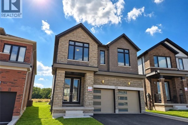 Front exterior of a two-story home at 578 Telfer Street, Woodstock, with stone and brick. - 578 Telfer Street, Woodstock